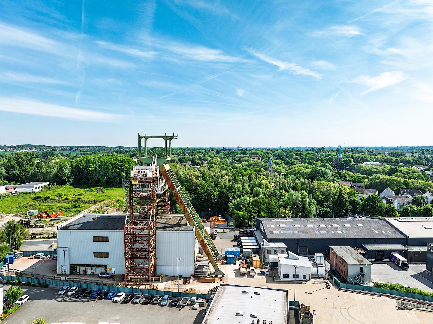 ehemaliger Förderturm in Bochum vor bewaldeter Stadtlandschaft